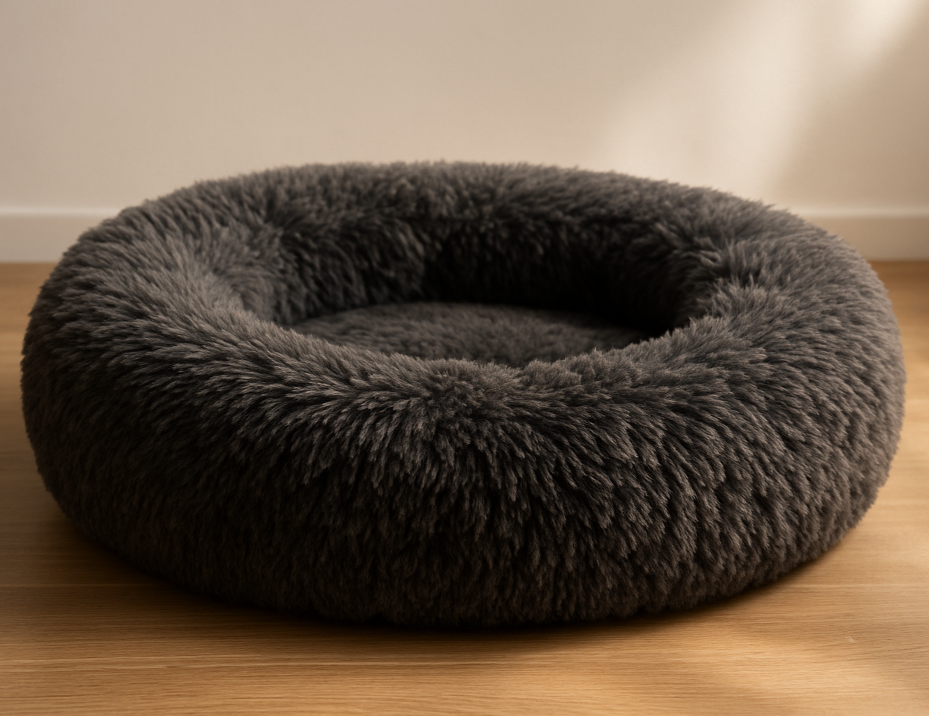 A fluffy charcoal-grey donut dog bed on its own. Soft natural lighting, cosy indoor setting with neutral white or soft-grey background. High quality product photography, suitable for an e-commerce website.